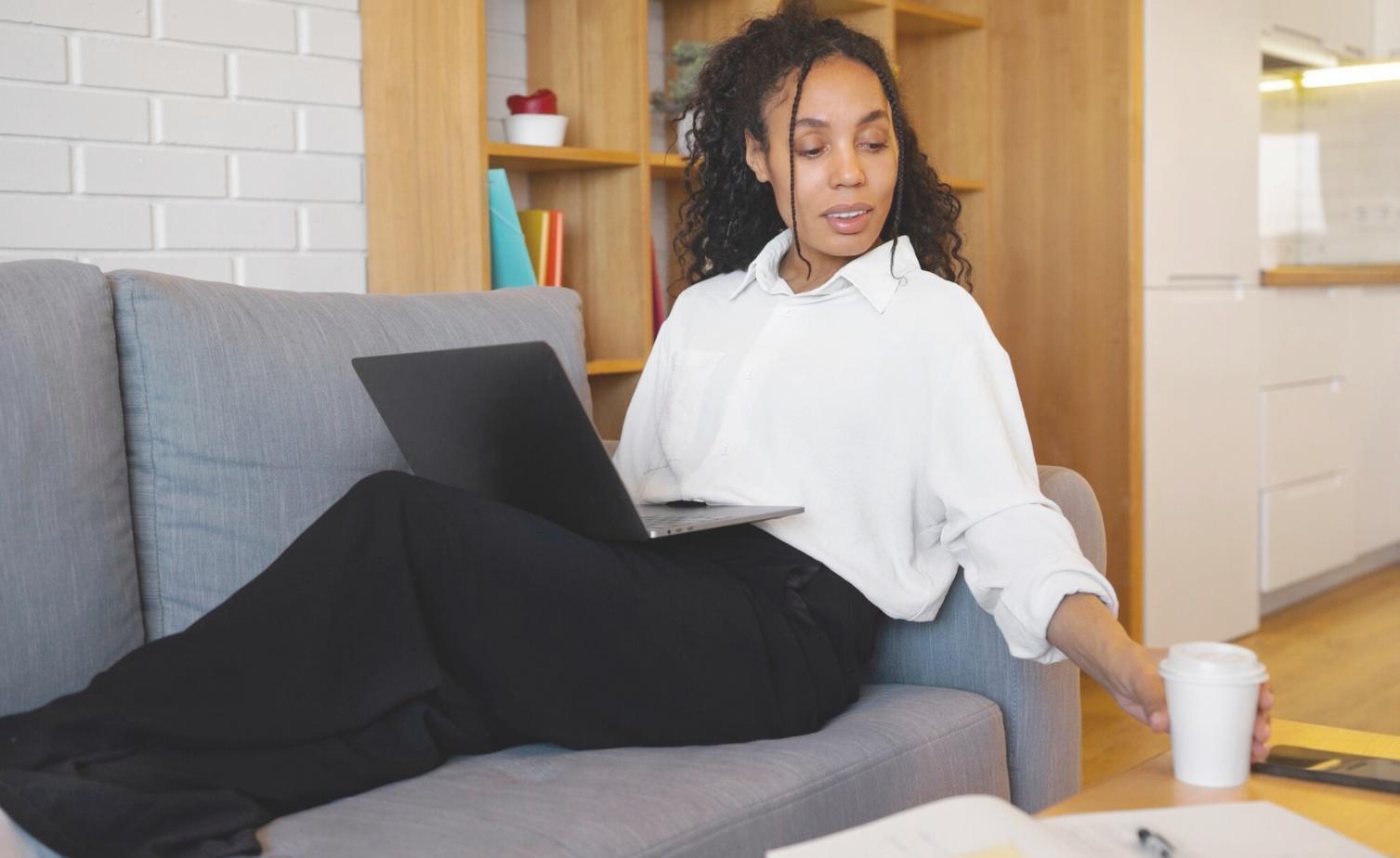 Person working on laptop with financial documents